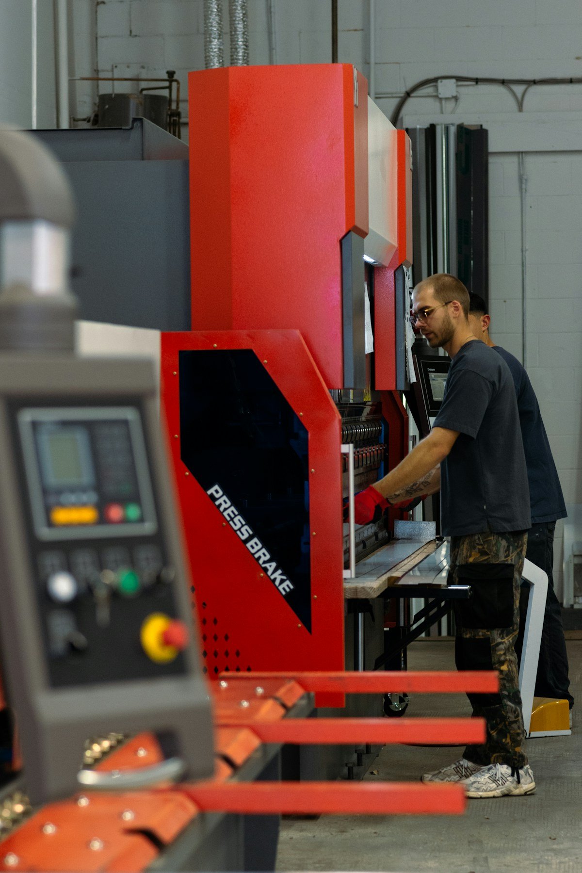 A manufacturing worker operating industrial equipment